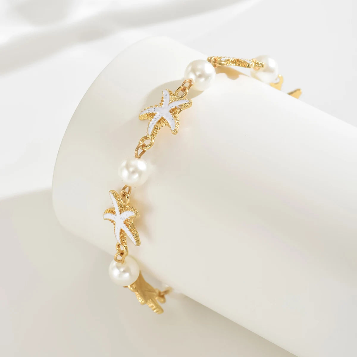 Cavigliera con stelle marine e perle